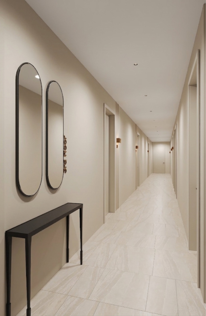 Residential corridor with paired oval mirrors and console