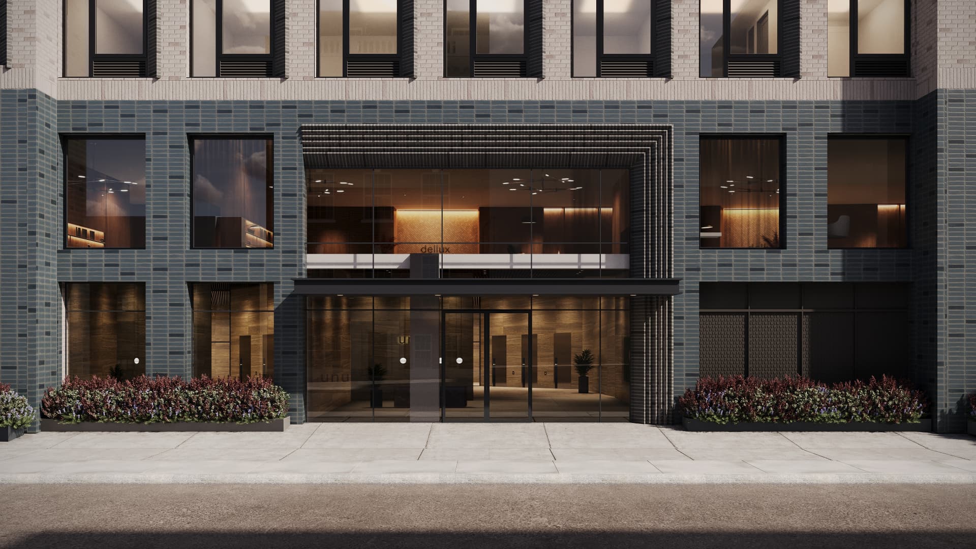 Residential entry at grade with layered brick canopy, bronzed reveals and planters