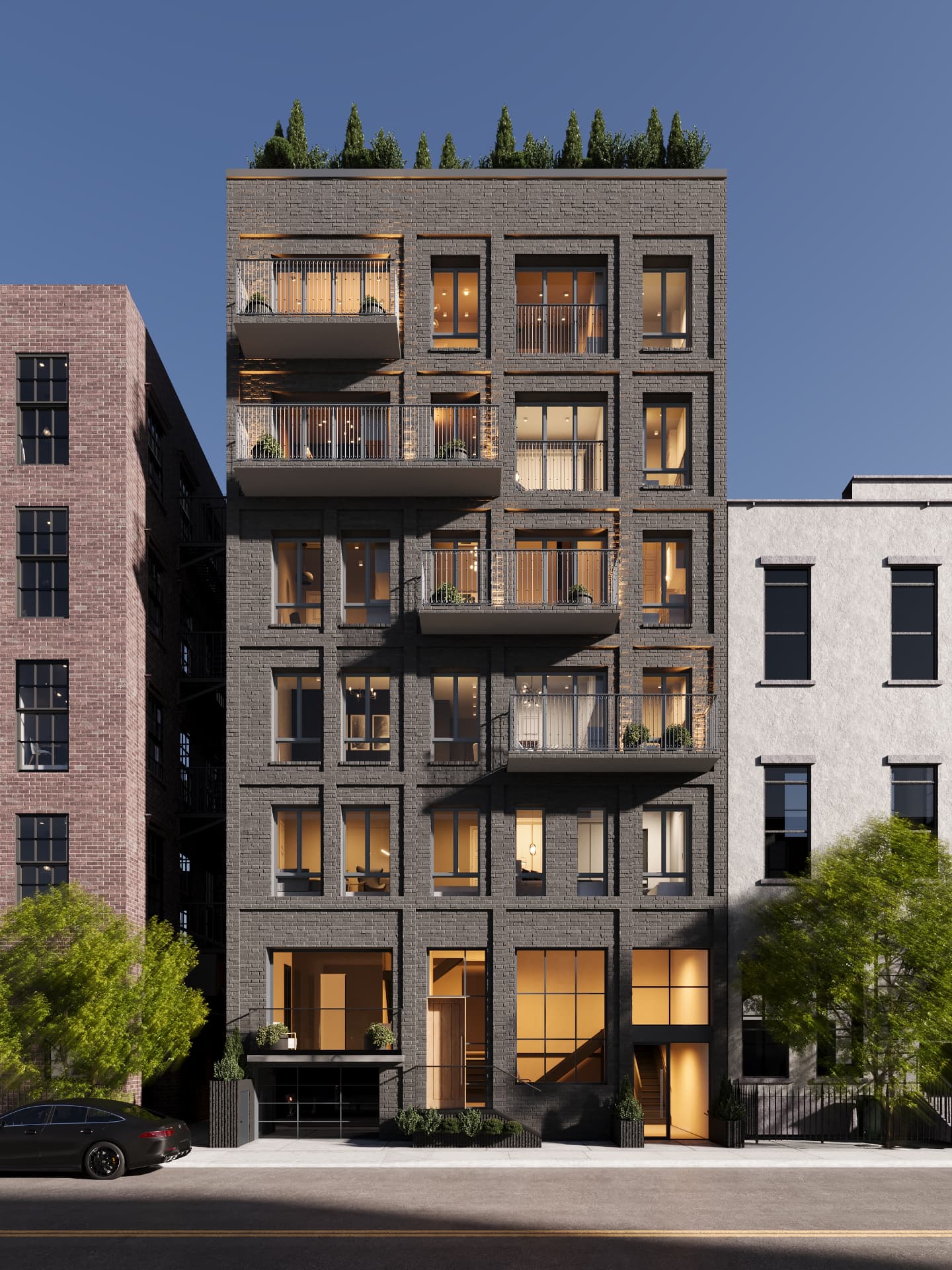 Street elevation of charcoal brick with steel balconies and rooftop evergreens
